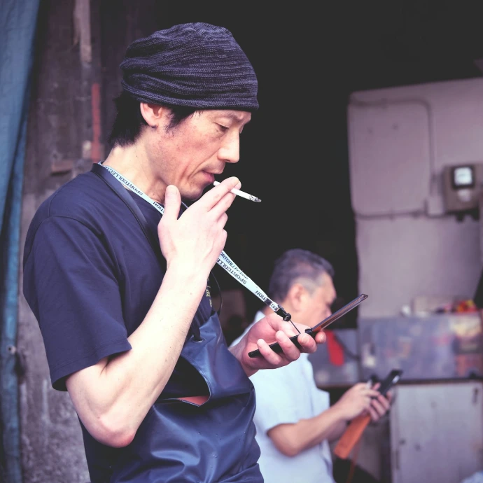 man smoking outside the house